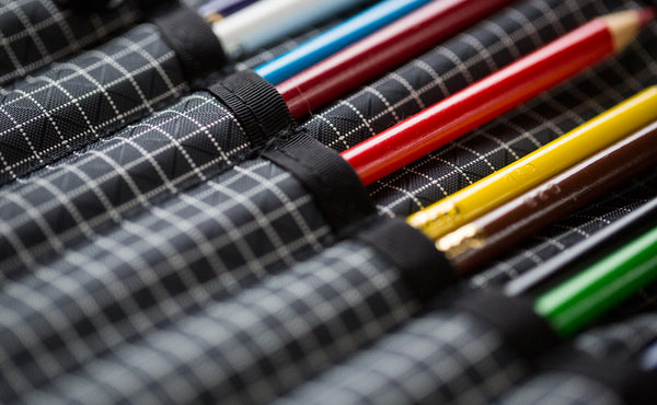 A close shot of the Tool Pen Wrap filled with colored pencils.